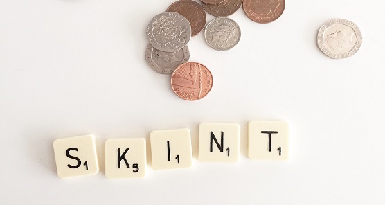 Picture of money with the word "skint" underneath