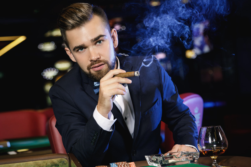 Canva-Rich-handsome-man-smoking-cigar-in-the-casino.jpg