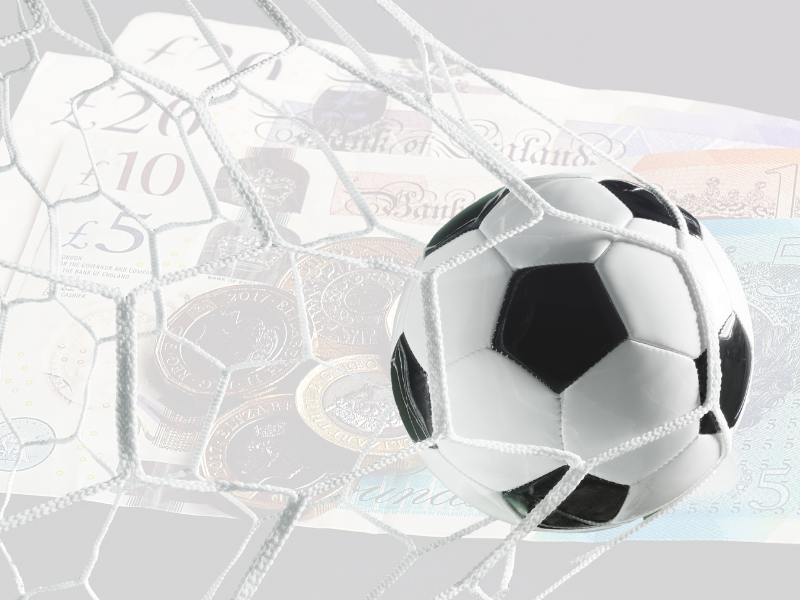 A picture of a football (OK fine - soccer ball) hitting the back of the net with a background that's highly transparent and shows UK bank notes. 